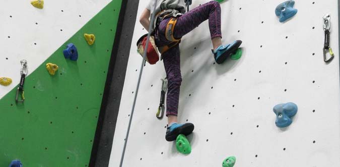 back of girl on climbing wall
