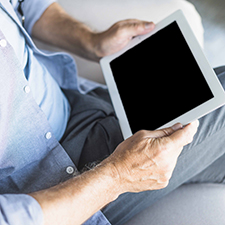 Senior man holding digital tablet