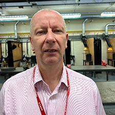 Nicky standing in a workshop on campus