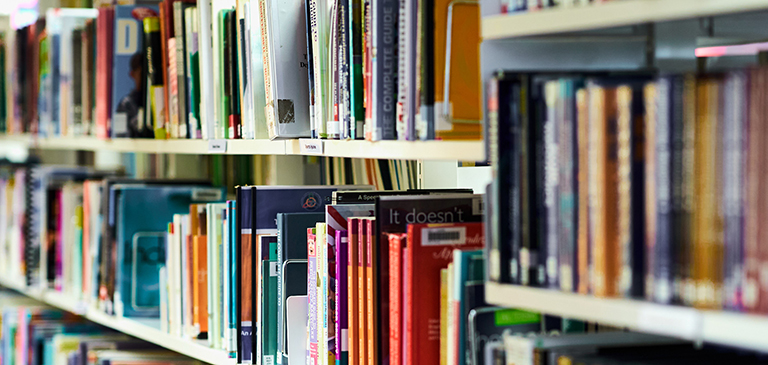 Rows of books on shelves in the library