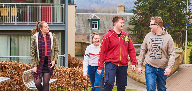 Students walking outside accommodation apartments