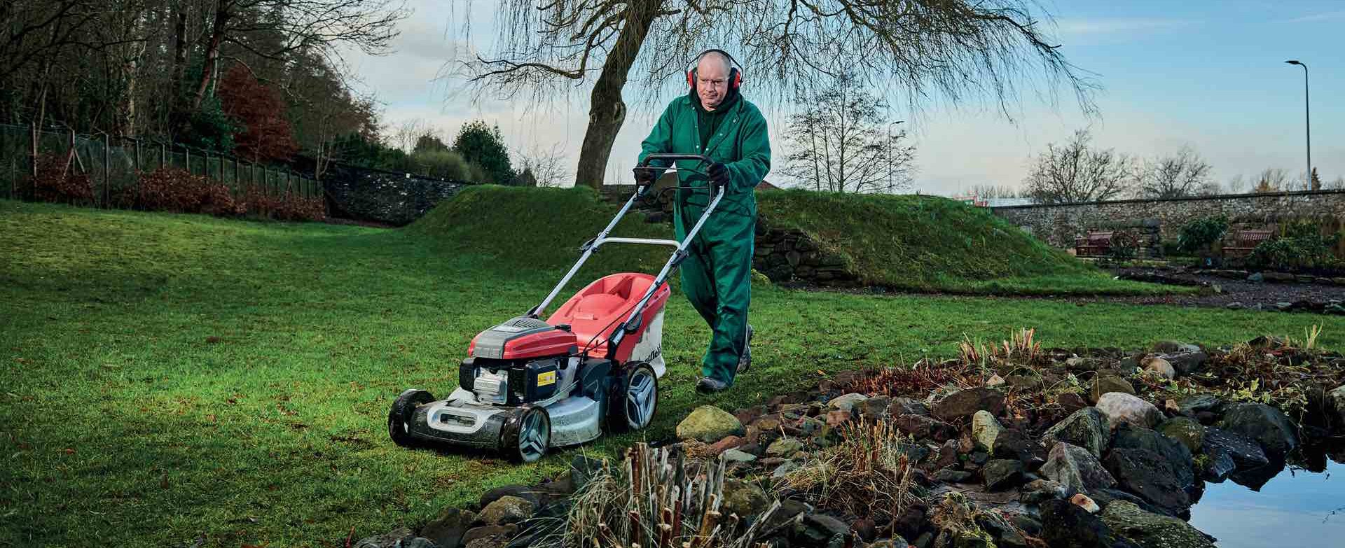 Student cutting grass in horticulture area