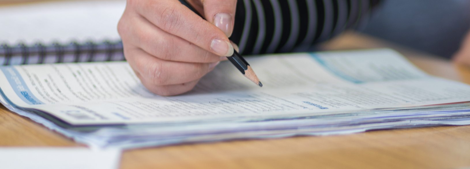 Student using pencil to answer written questions