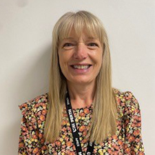 alison standing against a white wall