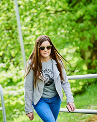 Student wearing sunglasses climbing steps