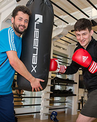 Fitness students with punchbag and boxing gloves