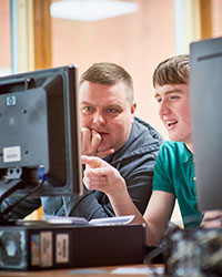 Two students looking at computer screen