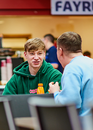 Two students chatting in cafe