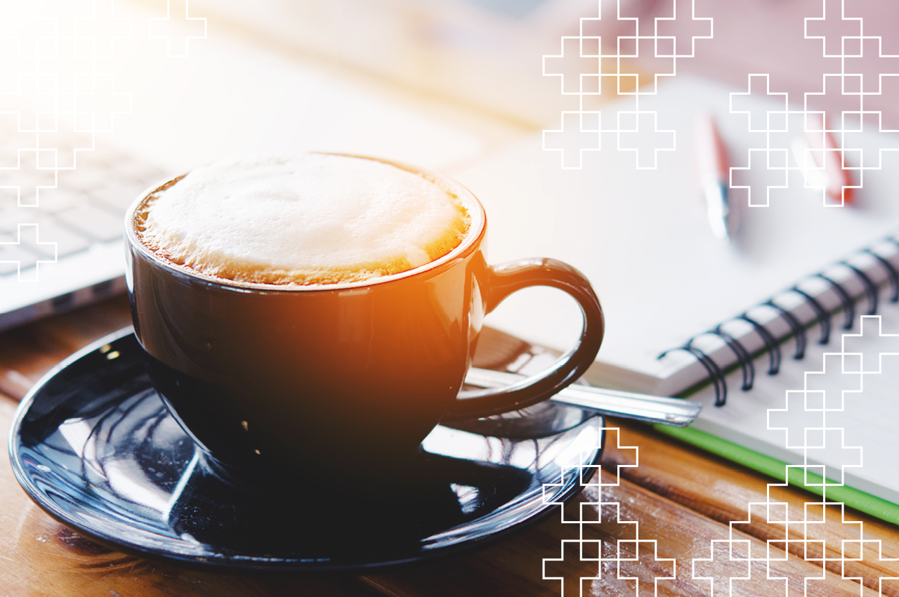 coffee and notepad sitting on a table