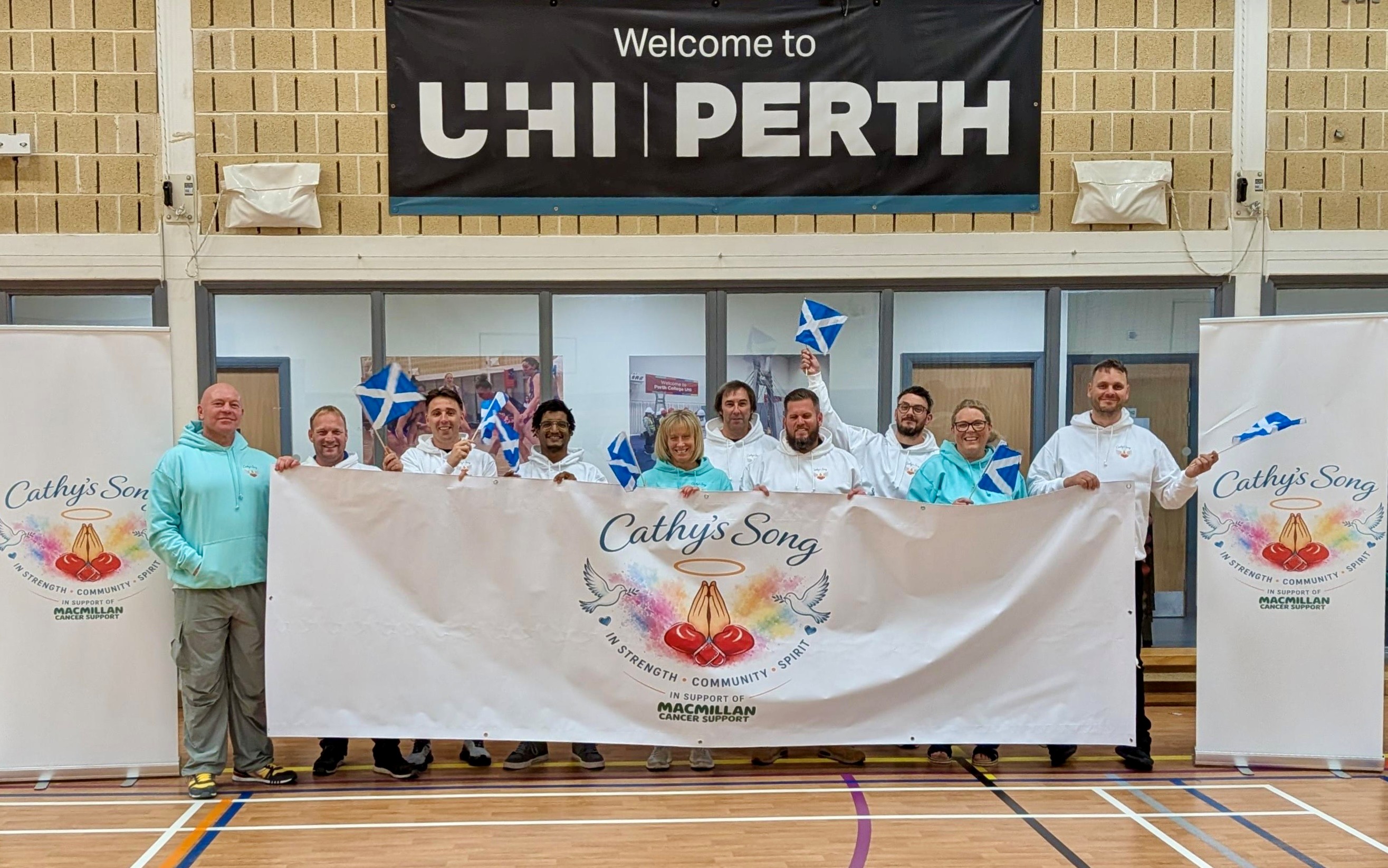 a group of people holding a white banner in the ASW