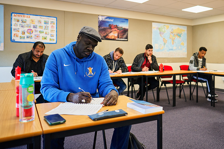 students sitting at desks writing