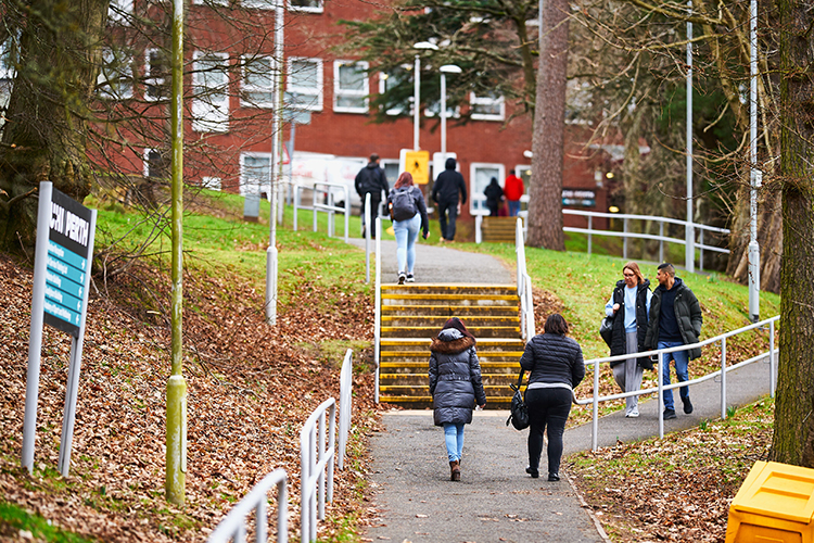 students walking up the stairs outside brahan on campus