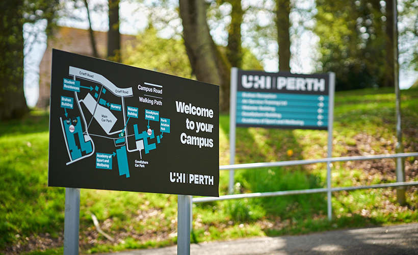 Welcome signage with a map of Perth campus, situated near trees Welcome signage with a map of Perth campus, situated near trees
