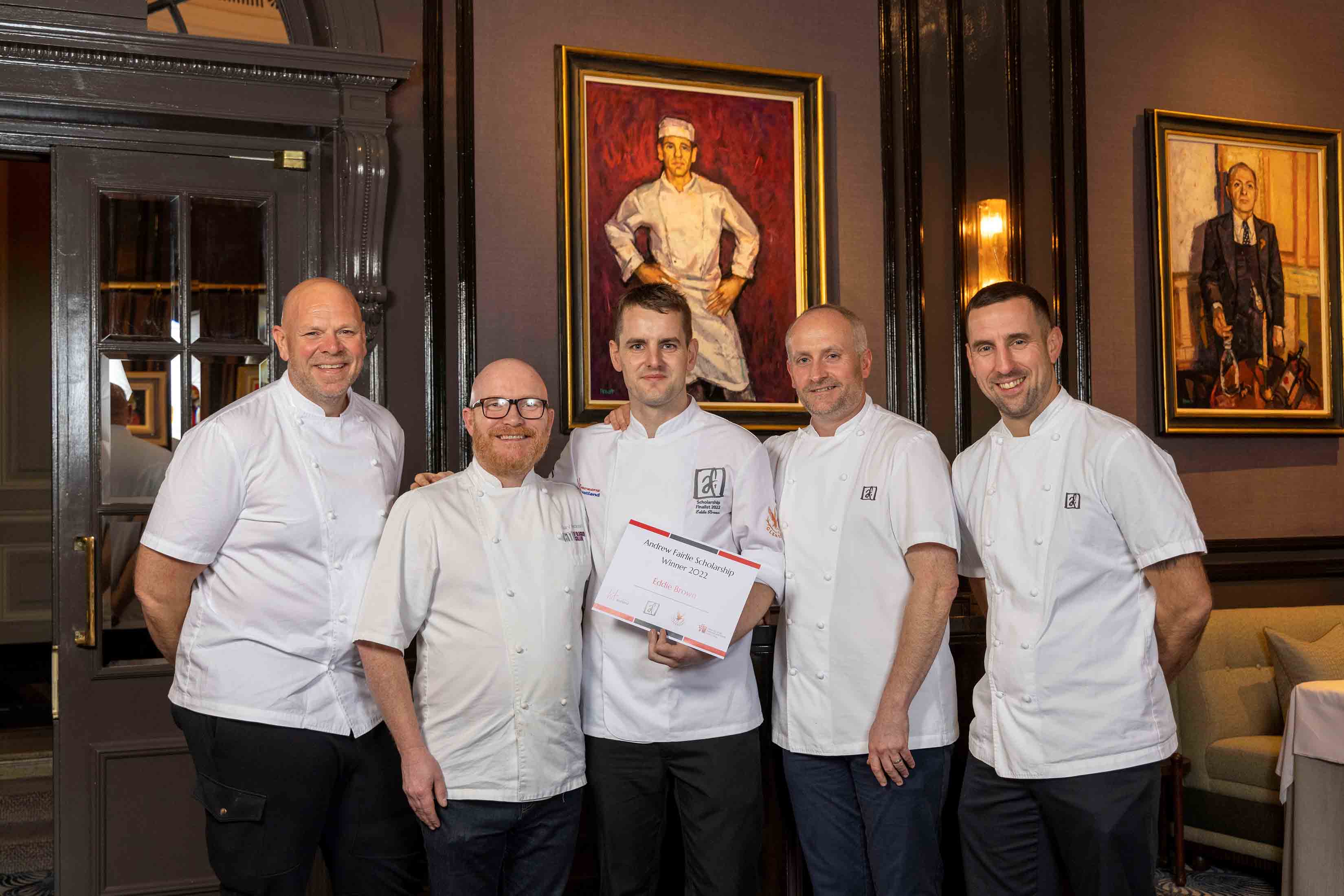 Chefs standing in a row with an award