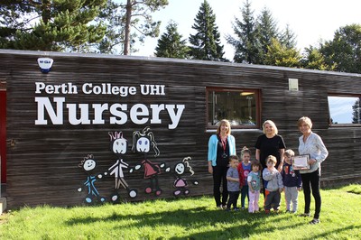 Staff and children outside nursery