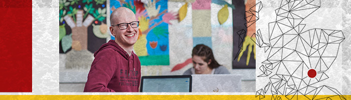 student smiling in a classroom