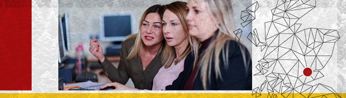 students and a lecturer looking at a computer