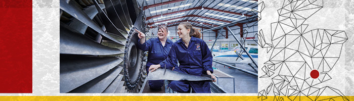 2 students looking at aeroplane engine