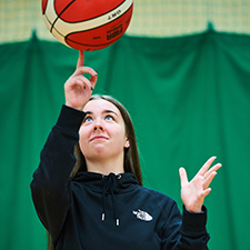 student spinning a ball in the games hall