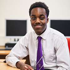 student in a classroom in a white shirt