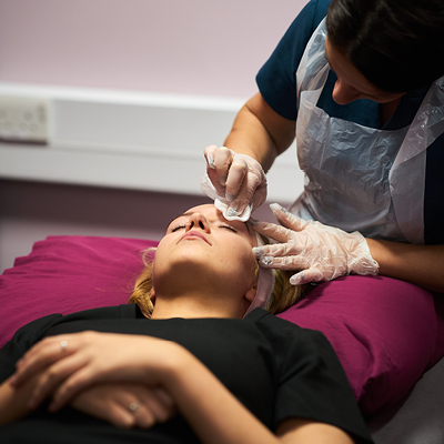 Student doing eyebrow treatment