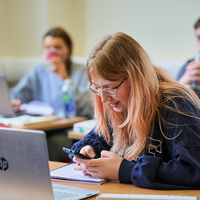 student taking notes on their phone