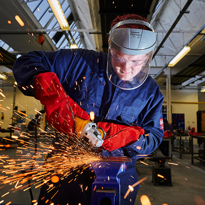 student using angle grinder