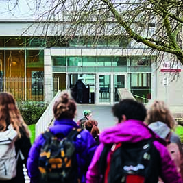 students walking up to goodlyburn building