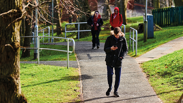 students walking up the hill on campus