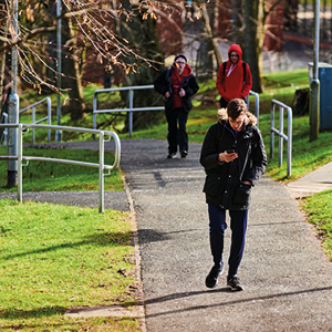 students walking up the hill on campus