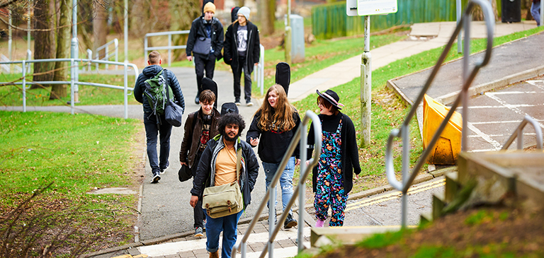 students walking up the campus stairs to Brahan