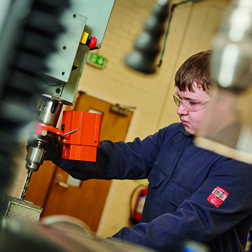 engineering student using machinery