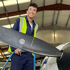 abdalla standing next to a plane