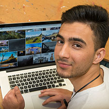 creative industries student on his computer