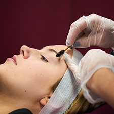 eyebrows being done on a cilent