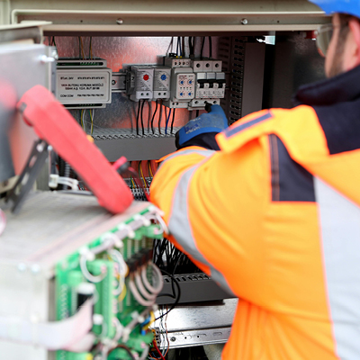 person working on electrical box unit