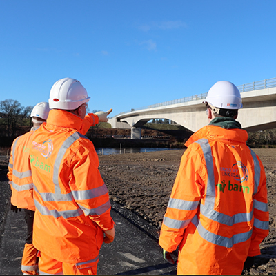 students looking at a bridge under construction