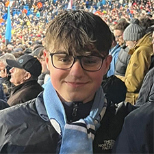 jack standing in a football stadium crowd