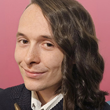 headshot of nathan with a pink background