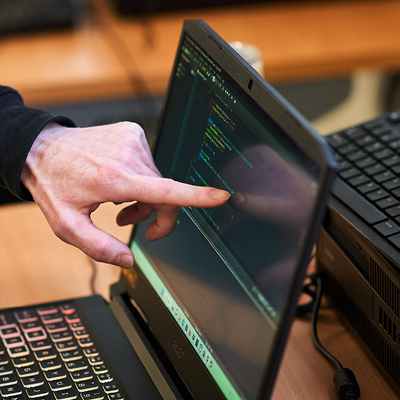 close up of student pointing at laptop screen