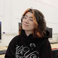 akira in the classroom in a black hoodie