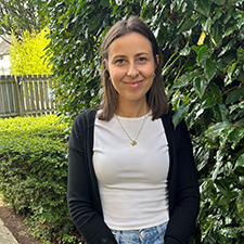 ameila standing next to a hedge