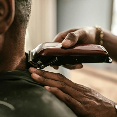 Person having their hair cut using clippers