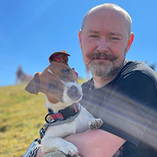 michal outside on a munro with his dog