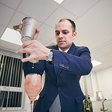 Hospitality student pouring cocktail