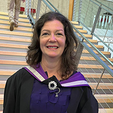 lorrraine standing in her graduation robe