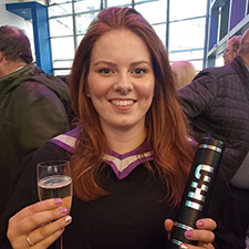 Molly holding a champagne glass and scroll