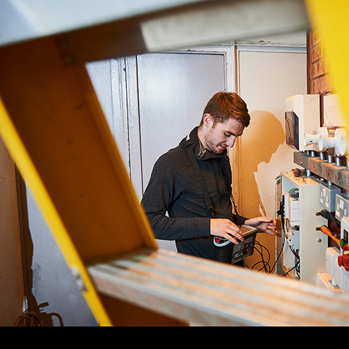 student working on electical equipment