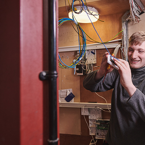 student working on electical equipment