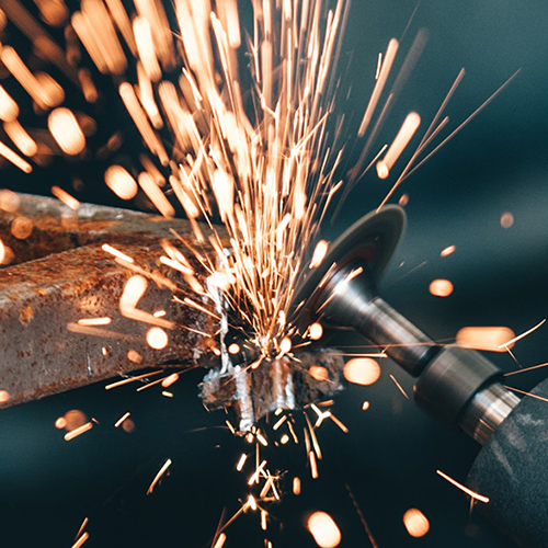 student welding a piece of metal